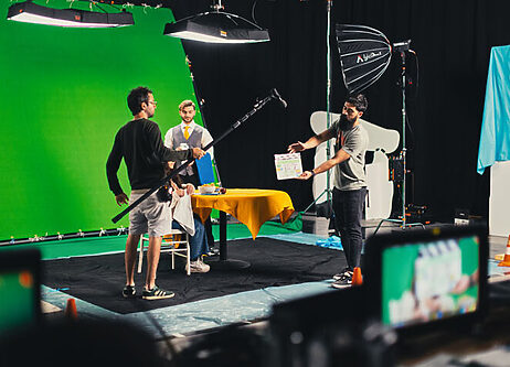 MAKA on set in front of green screen